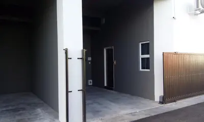 a room with a door and a wall with a gate at JQ Suria 18 Hotel in Ipoh