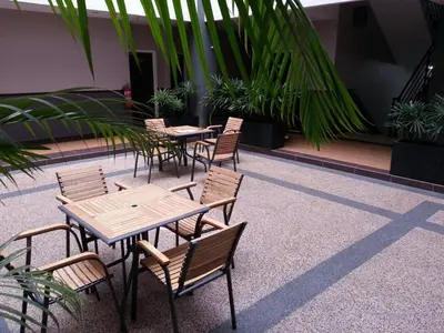 a group of tables and chairs in a courtyard at JQ Suria 18 Hotel in Ipoh