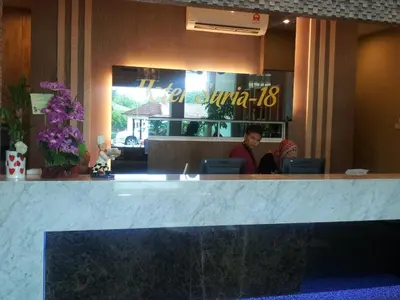 a woman sitting at a counter in a restaurant at JQ Suria 18 Hotel in Ipoh