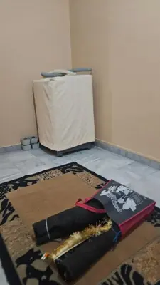 a rug sitting on the floor next to a refrigerator at Mount Lake Villa in Ipoh