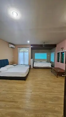 a large bedroom with two beds and a wooden floor at Mount Lake Villa in Ipoh