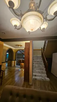 a large room with a staircase and a chandelier at Mount Lake Villa in Ipoh