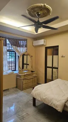 a bedroom with a ceiling fan and a mirror at Mount Lake Villa in Ipoh