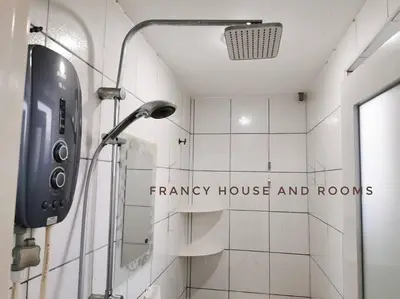 a shower in a bathroom with a sign on the wall at Semi-D Landed House Bercham Ipoh in Ipoh