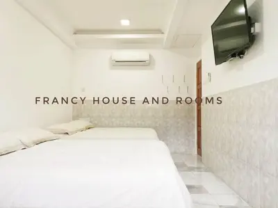 a bedroom with a white bed and a tv at Semi-D Landed House Bercham Ipoh in Ipoh