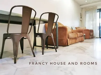 a dining table and two chairs in a living room at Semi-D Landed House Bercham Ipoh in Ipoh