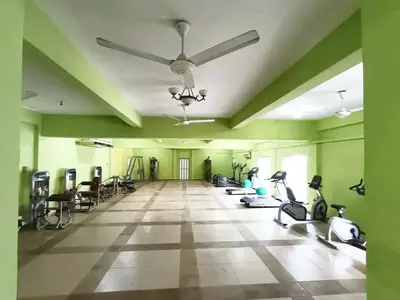 a gym with treadmills and exercise equipment in a room at Collection O Analisa Beach Resort in Pangkor