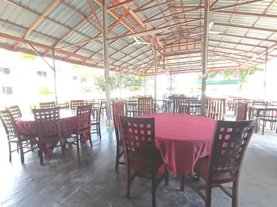 a dining room with a red table and chairs at Collection O Analisa Beach Resort in Pangkor