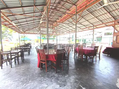 a restaurant with tables and chairs with red table cloth at Collection O Analisa Beach Resort in Pangkor
