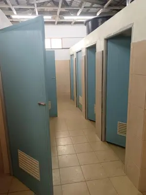 a row of blue doors in a hallway at Kuala Woh Resort in Tapah