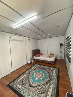 a room with a bed and a rug on the floor at YN cabin in Tanjung Karang