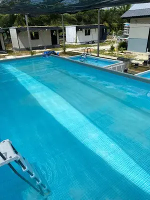a large swimming pool with blue water at YN cabin in Tanjung Karang