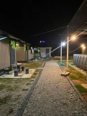 an empty parking lot at night with lights on at YN cabin in Tanjung Karang