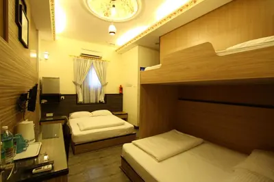 a bedroom with two beds and a clock on the ceiling at Shamrock Guest House II in Ipoh
