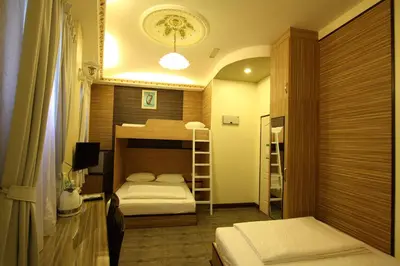 a bedroom with two beds and a bunk bed at Shamrock Guest House II in Ipoh