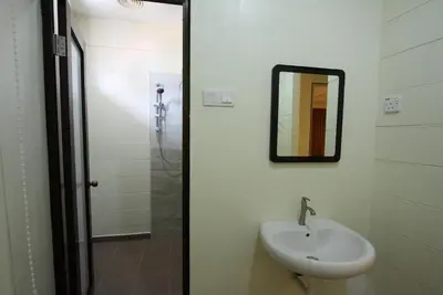 a bathroom with a sink and a mirror at Shamrock Guest House II in Ipoh