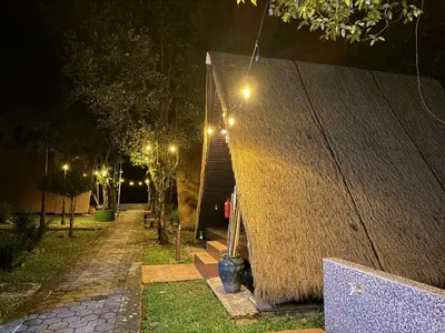 a building with a staircase with lights on it at night at Chalet Kuala Woh Resort in Tapah