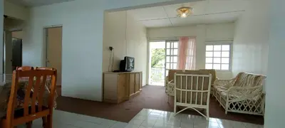 a living room with a couch and a tv at Desa Anthurium Apartment in Tanah Rata