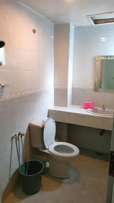 a bathroom with a toilet and a sink at Desa Anthurium Apartment in Tanah Rata