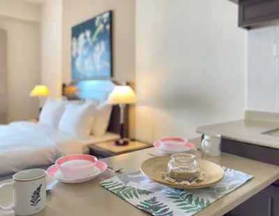 a table with a plate of food on it with a bed at Rainbow Paradise with Beach in Tanjung Bungah in Tanjung Bungah