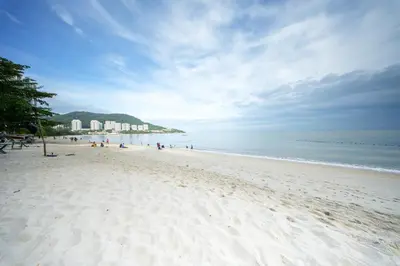 a group of people on a beach with the ocean at Rainbow Paradise with Beach in Tanjung Bungah in Tanjung Bungah