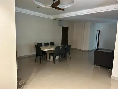 a dining room with a table and chairs and a ceiling fan at Orkid Apartment 2 in Cameron Highlands