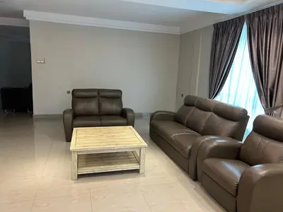 a living room with a couch and a coffee table at Orkid Apartment 2 in Cameron Highlands