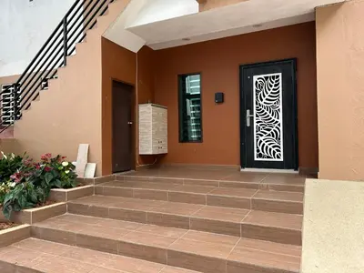 a front door of a house with a door at Orkid Apartment 2 in Cameron Highlands