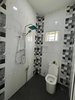 a bathroom with a toilet and a shower at Homestay Bajet Cikgu Amin in Bagan Serai
