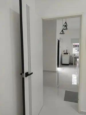 an open door to a room with white walls at Homestay Bajet Cikgu Amin in Bagan Serai