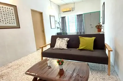 a living room with a couch and a coffee table at Pepper Hillside Village Home in Tanjung Bungah
