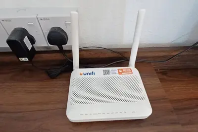 a laptop computer sitting on top of a wooden floor at Pepper Hillside Village Home in Tanjung Bungah