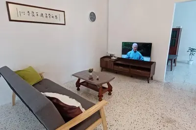 a living room with a couch and a tv at Pepper Hillside Village Home in Tanjung Bungah