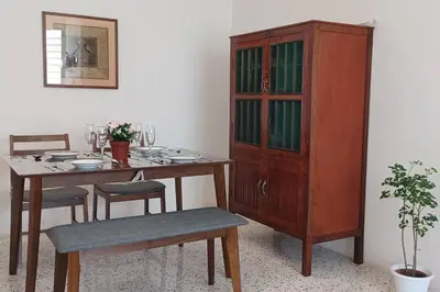 a dining room with a table and a cabinet at Pepper Hillside Village Home in Tanjung Bungah