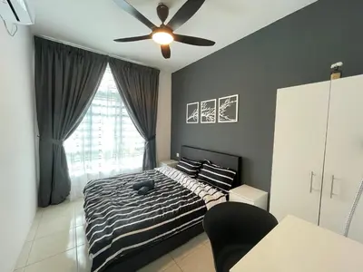 a bedroom with a bed and a ceiling fan at Ipoh Town The Anderson Residence in Ipoh