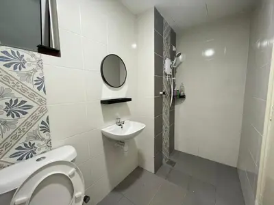 a bathroom with a toilet and a sink at Ipoh Town The Anderson Residence in Ipoh