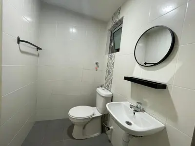 a white bathroom with a toilet and a sink at Ipoh Town The Anderson Residence in Ipoh