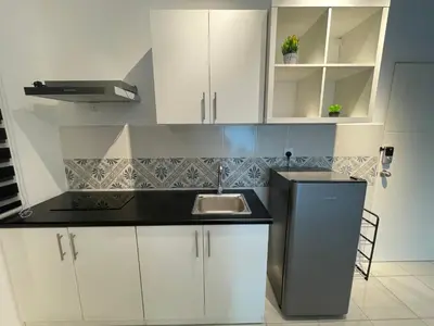 a kitchen with white cabinets and a sink at Ipoh Town The Anderson Residence in Ipoh