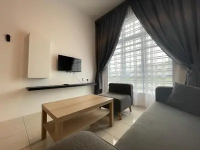 a living room with a couch and a table and a window at Ipoh Town The Anderson Residence in Ipoh