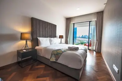a bedroom with a large bed with a large window at The Landmark Seaview Suite in Tanjong Tokong