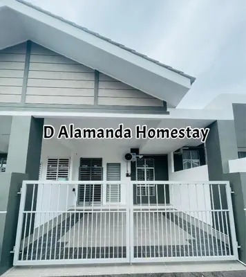 a house with a white fence in front of it at D Alamanda Islam Homestay in Kuala Kangsar