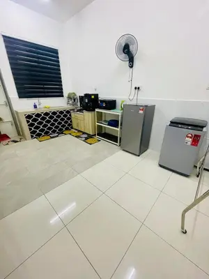 a kitchen with a white floor and a fan at D Alamanda Islam Homestay in Kuala Kangsar