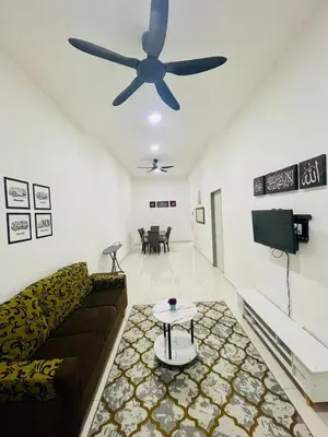 a living room with a couch and a ceiling fan at D Alamanda Islam Homestay in Kuala Kangsar