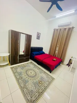 a living room with a bed and a ceiling fan at D Alamanda Islam Homestay in Kuala Kangsar