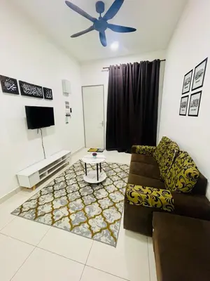 a living room with a couch and a ceiling fan at D Alamanda Islam Homestay in Kuala Kangsar