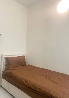 a bed in a white room with a brown blanket at Batu Ferringhi Home Near Beach in Penang in Batu Ferringhi