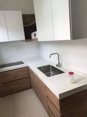 a kitchen with a sink and white cabinets at Batu Ferringhi Home Near Beach in Penang in Batu Ferringhi