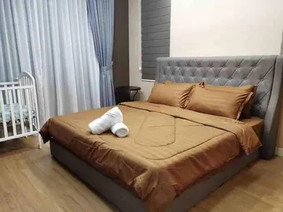 a large bed with a white stuffed animal on it at Batu Ferringhi Home Near Beach in Penang in Batu Ferringhi