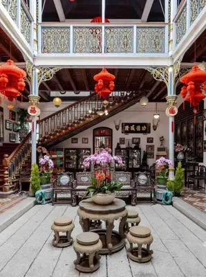 a building with a table with a vase of flowers at Heritage Cottage in Georgetown in Jelutong