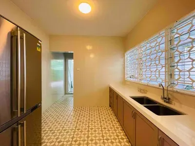 a large kitchen with a sink and a window at Heritage Cottage in Georgetown in Jelutong
